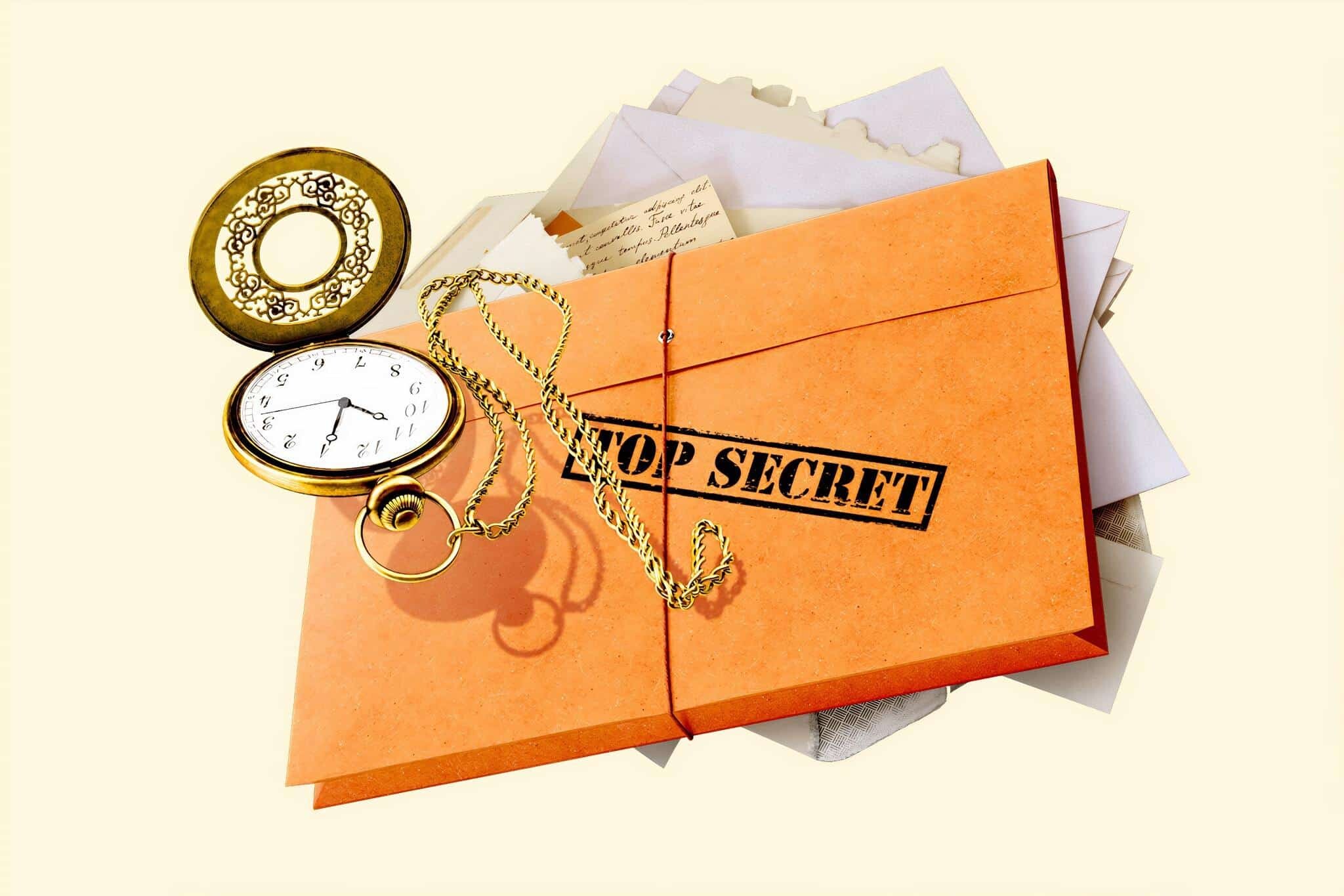 Folder with top secret written on the cover and a pocket watch over the folder.