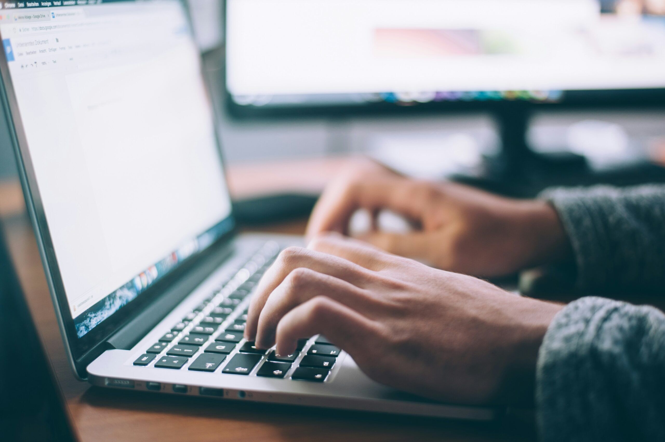 photo of person typing on computer